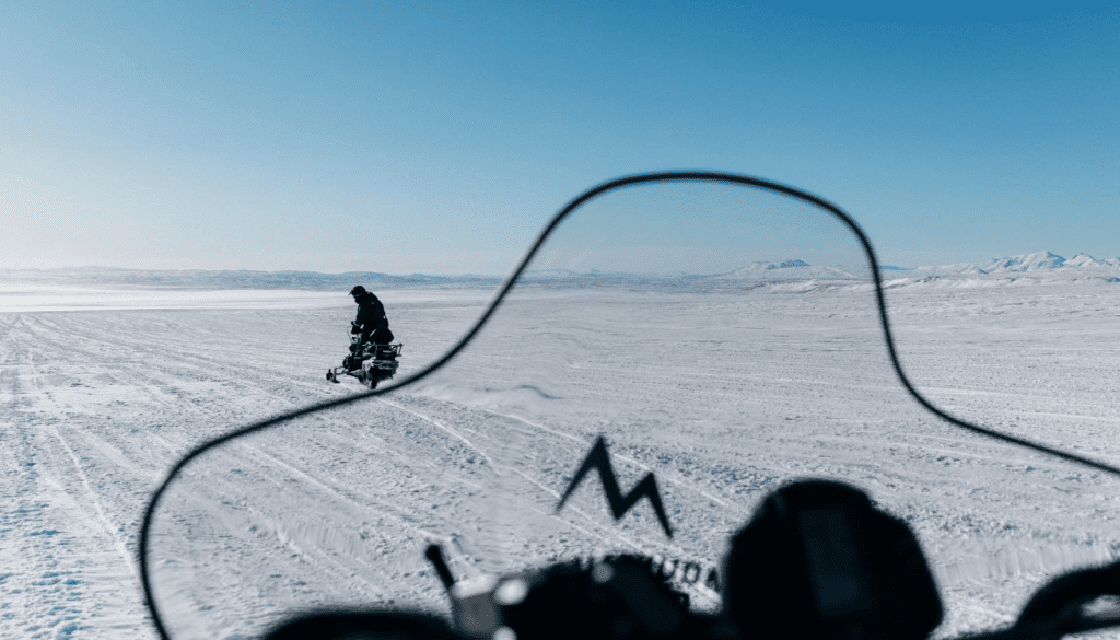 Snowmobile following a guide