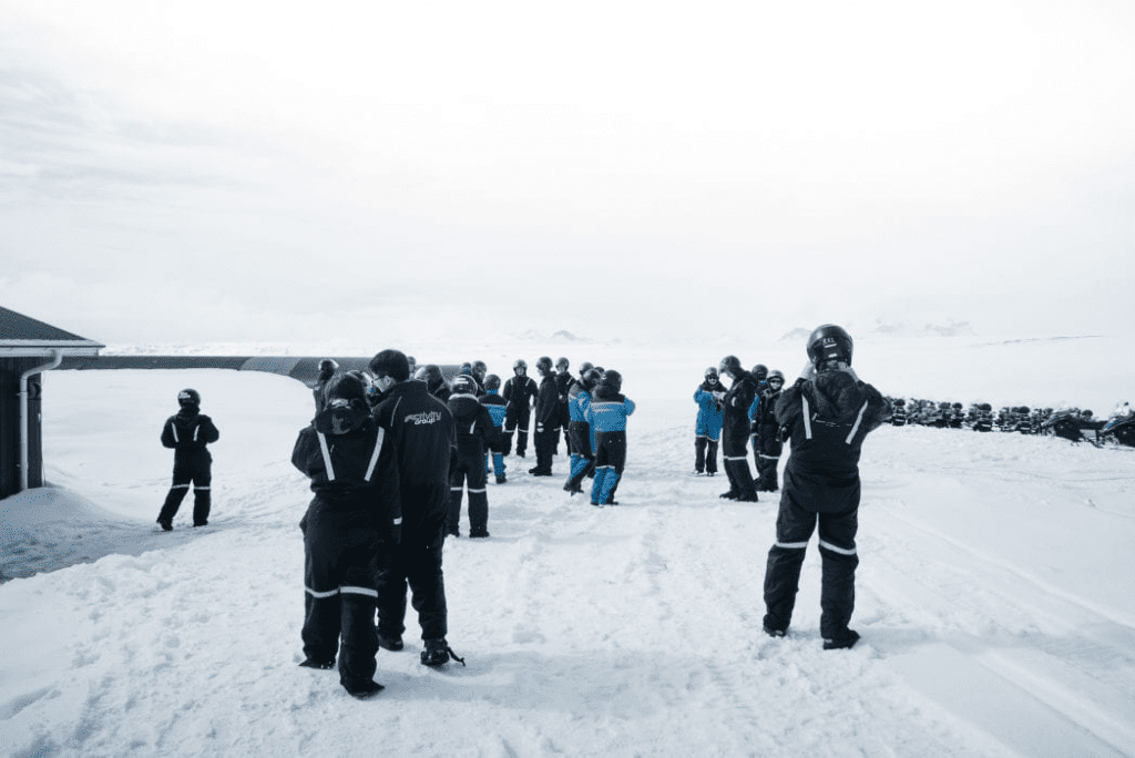 People in snowmobile gear